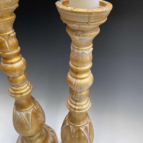 155 - A pair of candleholders decorated with acanthus leaf design, height 63cm.