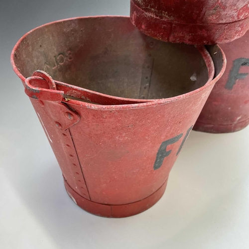 175 - Three red painted 'FIRE' buckets, one with a War Ministry broad arrow, tallest height 28.5cm.