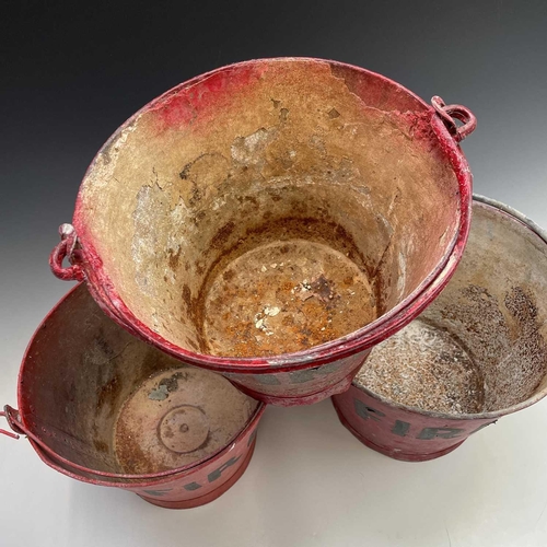 175 - Three red painted 'FIRE' buckets, one with a War Ministry broad arrow, tallest height 28.5cm.