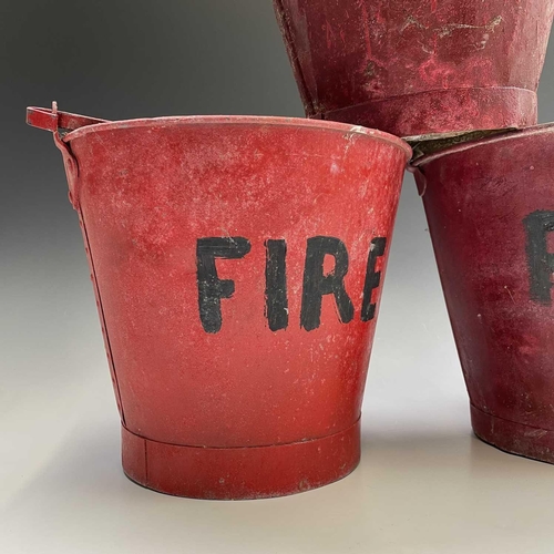 175 - Three red painted 'FIRE' buckets, one with a War Ministry broad arrow, tallest height 28.5cm.