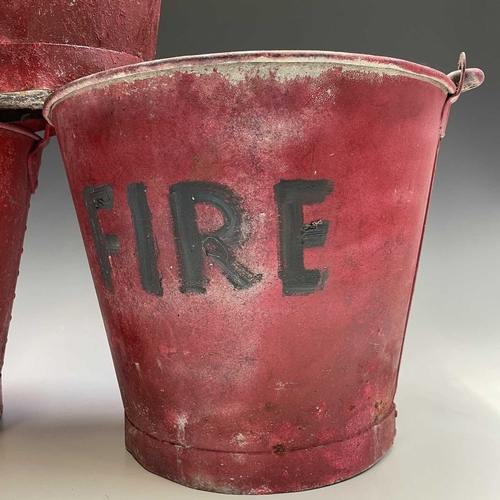 175 - Three red painted 'FIRE' buckets, one with a War Ministry broad arrow, tallest height 28.5cm.