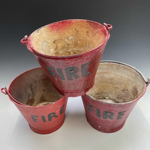 175 - Three red painted 'FIRE' buckets, one with a War Ministry broad arrow, tallest height 28.5cm.