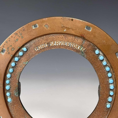 180 - An early 20th century copper frame in the form of an inverted horseshoe decorated with turquoise bea... 