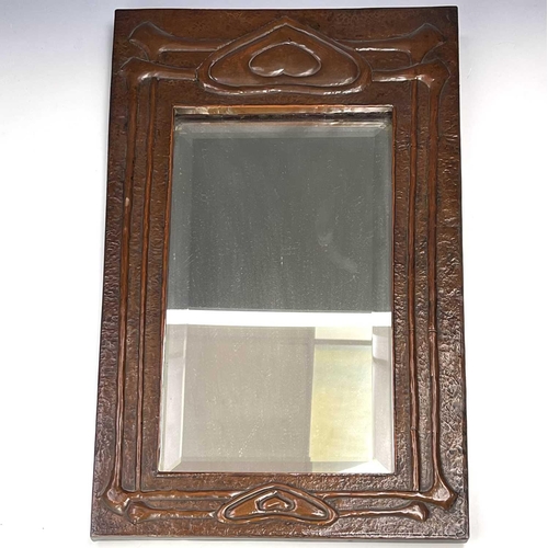 2 - A Glasgow School Arts and Crafts copper framed mirror, circa 1900, embossed with heart motifs and si... 