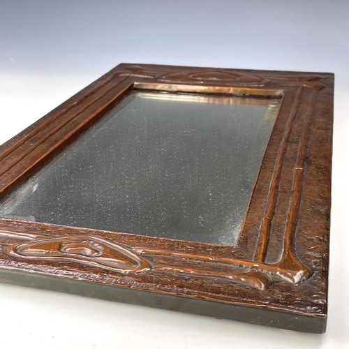 2 - A Glasgow School Arts and Crafts copper framed mirror, circa 1900, embossed with heart motifs and si... 