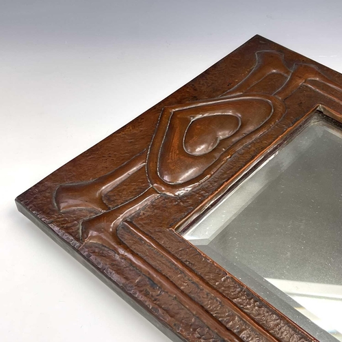 2 - A Glasgow School Arts and Crafts copper framed mirror, circa 1900, embossed with heart motifs and si... 