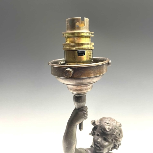 23 - After Auguste Moreau, a bronzed lamp, modelled as a cherubic youth supporting the torch in his raise... 