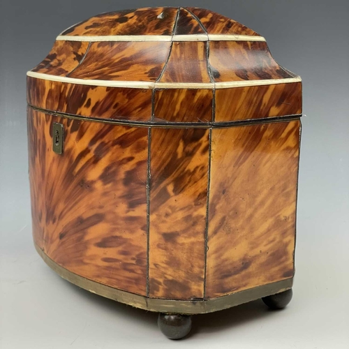 24 - An early Victorian bow front tortoiseshell tea caddy, with two internal lidded compartments, on ball... 