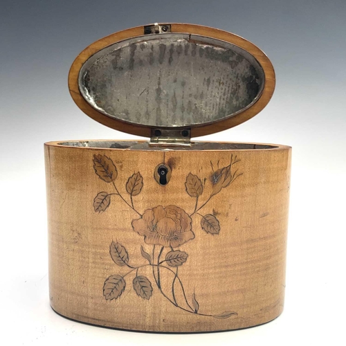 27 - A George III oval satinwood tea caddy, with floral and trailing foliate inlay and lidded compartment... 