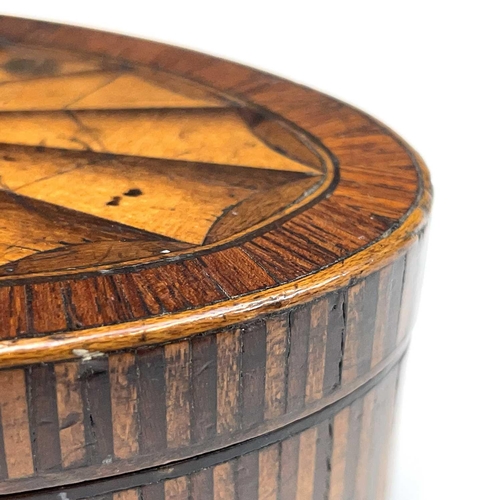 28 - A George III mahogany, crossbanded and satinwood inlaid oval trinket box, with large paterae to the ... 