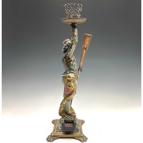 3 - A Venetian blackamoor gondolier figure, circa 1900, with painted and gilt decoration, modelled stand... 