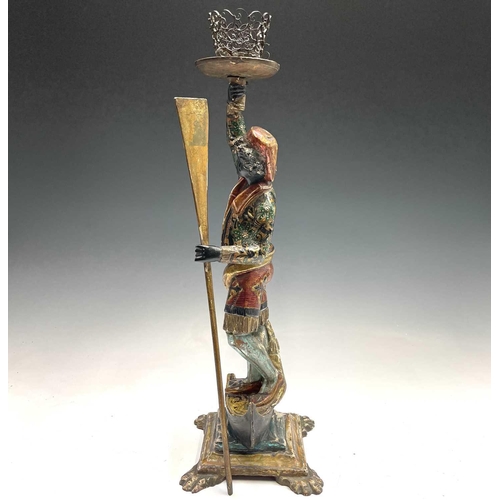 3 - A Venetian blackamoor gondolier figure, circa 1900, with painted and gilt decoration, modelled stand... 