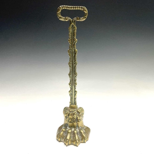 317 - A Victorian brass lion's paw doorstop, height 37cm.