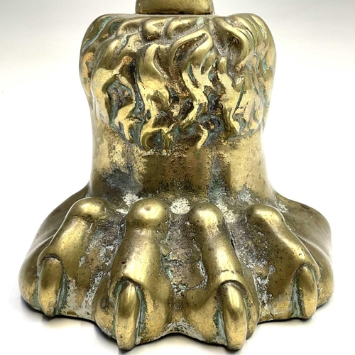 317 - A Victorian brass lion's paw doorstop, height 37cm.