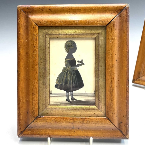 32 - An early 19th century silhouette, of a young girl, in a coastal setting holding a toy dog, heightene... 