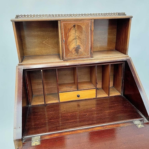 3204 - A 20th century mahogany crossbanded bureau the fall front enclosing a fitted interior above a single... 