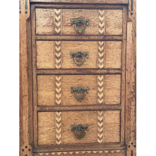 3206 - A Victorian Gothic revival oak ebony and boxwood inlaid twin pedestal desk, with an arrangement of e... 