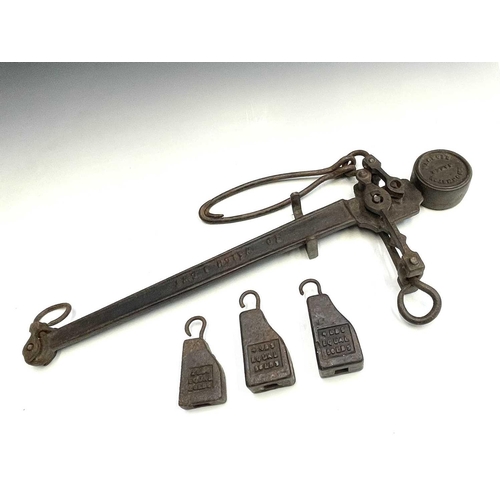 323 - A cast iron steelyard balance marked R Johnstone Maker REDRUTH with three weights, length 78cm.