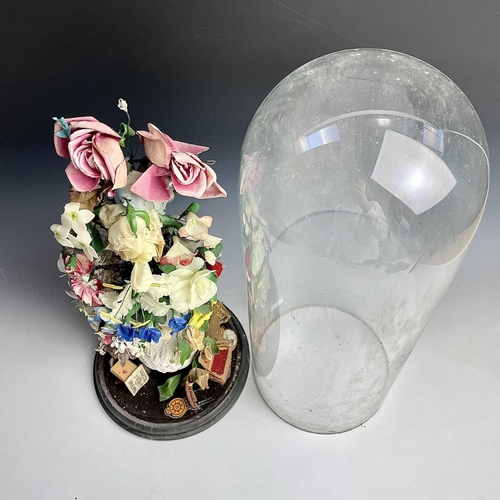 33 - A Victorian glass dome, containing a display of artificial flowers in a vase, on ebonised stand, ove... 