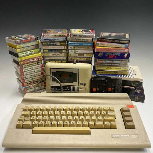 350 - A Commodore 64 with an original cassette tape player, manual and various games.