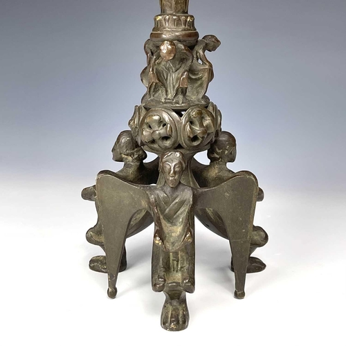 36 - A pair of late 19th century bronze ecclesiastical gothic candlesticks, the bases modelled with three... 