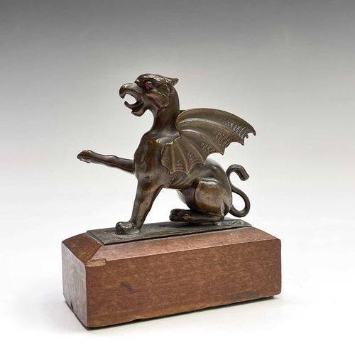 39 - A bronze figure of a wyvern, with inset eyes and raised paw, width 8cm, together with a Russian iron... 