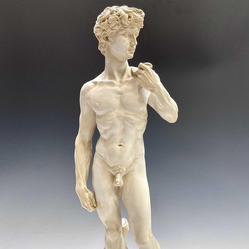 40 - A composite marble statue of Michelangelo's David on a marble base by G Ruggeri signed, height 72cm.