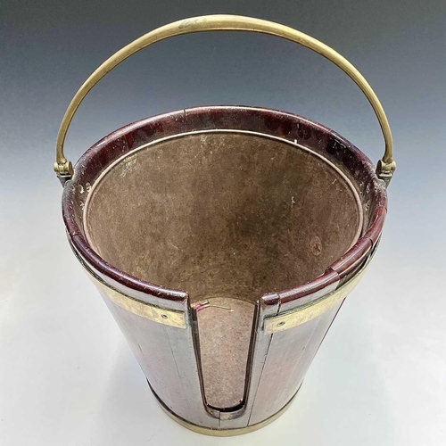 5 - A George III mahogany and brass bound plate bucket, the brass swing handle with decorative scroll te... 