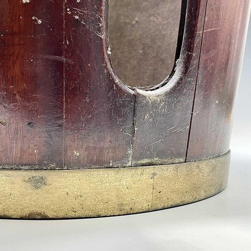 5 - A George III mahogany and brass bound plate bucket, the brass swing handle with decorative scroll te... 