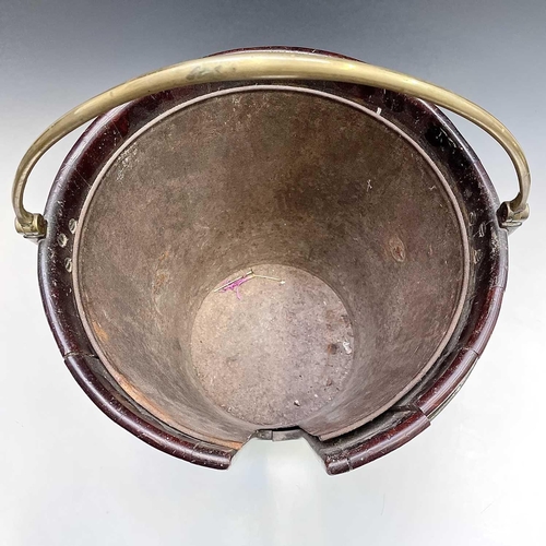 5 - A George III mahogany and brass bound plate bucket, the brass swing handle with decorative scroll te... 