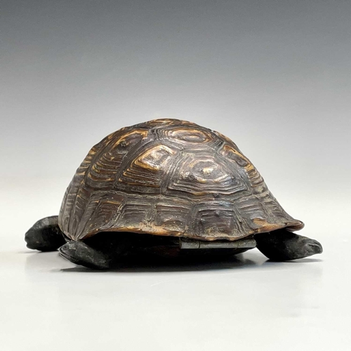 53 - A box and cover, in the form of a tortoise, circa 1920, with natural shell cover and composition hea... 