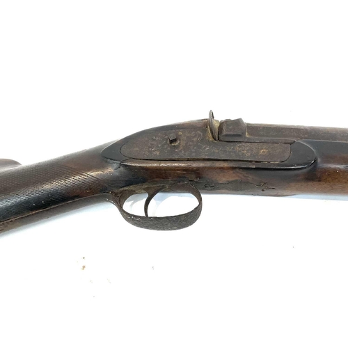 60 - A 19th century single barrel percussion rifle with walnut stock and textured grip with a ramrod, and... 