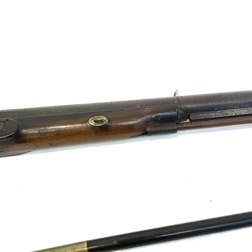 60 - A 19th century single barrel percussion rifle with walnut stock and textured grip with a ramrod, and... 