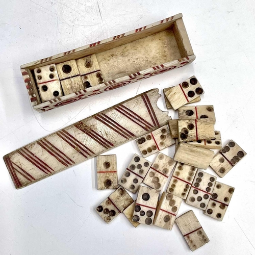 62 - A set of Napoleonic bone prisoner of war miniature dominoes, the case with sliding lid and red incis... 