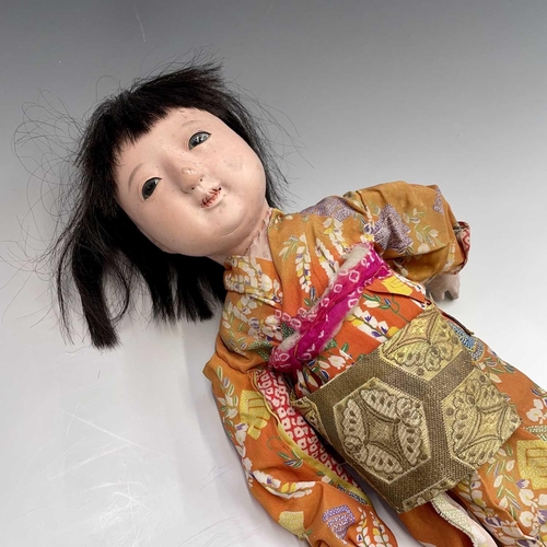 68 - A Japanese composition head doll, 20th century, in traditional costume, height 48cm, together with t... 