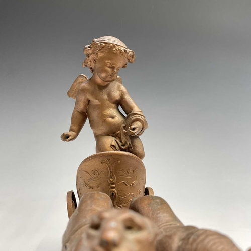 70 - A pair of late 19th/early 20th spelter figure groups, each modelled as a cherub standing in a chario... 