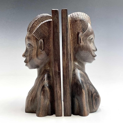 71 - A pair of African ironwood bookends carved with a male and female in high relief, height 21cm.