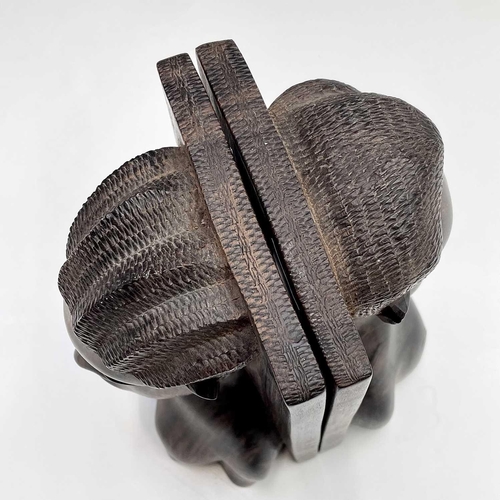 71 - A pair of African ironwood bookends carved with a male and female in high relief, height 21cm.