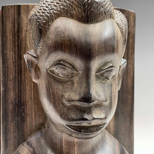 71 - A pair of African ironwood bookends carved with a male and female in high relief, height 21cm.