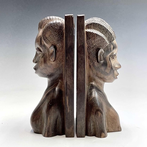 71 - A pair of African ironwood bookends carved with a male and female in high relief, height 21cm.