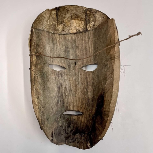 74 - An African mask with snakeskin detail, length 37cm.