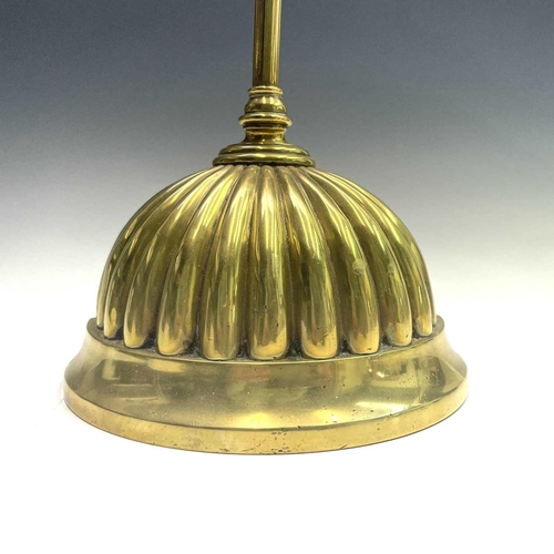 9 - A Regency brass and cast iron door porter, with scrolled top and fluted half round base, height 42cm... 