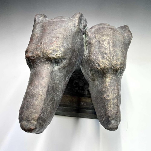 91 - A heavy bronzed composition sculpture of a pair of greyhound heads, on a plinth base. Height 29cm, w... 