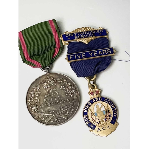 254 - Military and other Medals and Badges. A hallmarked silver Army Rifle Association medal, an A.C.C. 