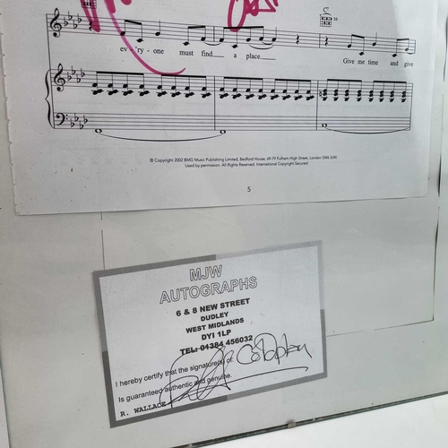 941 - Coldplay Autograph. A framed personally signed score for 