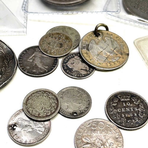 144 - Silver World Coinage - 19th and 20th Century. A bag containing approximately 25 coins in varying gra... 