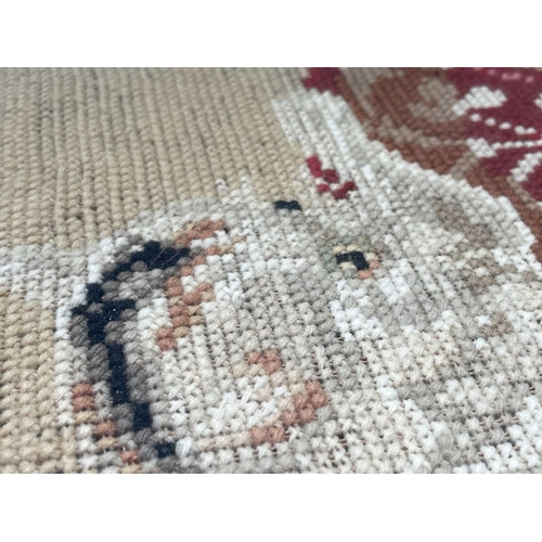 2800 - A Victorian Berlin woolwork picture of a cat, seated on a cushion, with Greek key lower border, cont... 