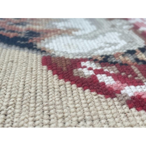 2800 - A Victorian Berlin woolwork picture of a cat, seated on a cushion, with Greek key lower border, cont... 