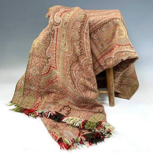 2801 - A Victorian paisley wool shawl with harlequin fringe, 332cm x 160cm.