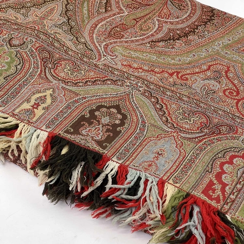 2801 - A Victorian paisley wool shawl with harlequin fringe, 332cm x 160cm.